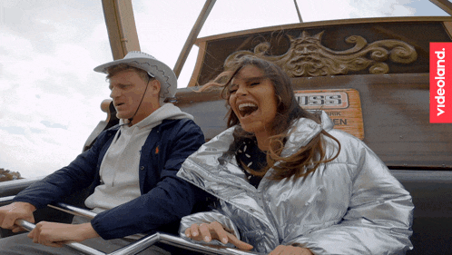 a man and woman are riding a ride with a sign that says viss