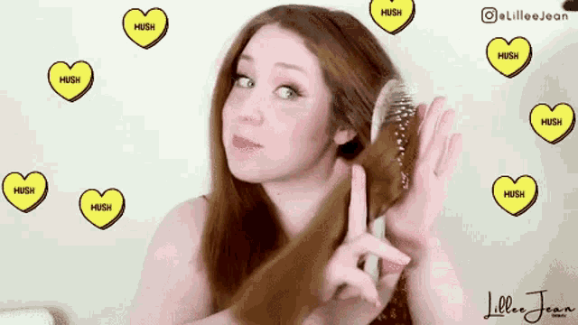 a woman is brushing her hair with hearts that say hush on them