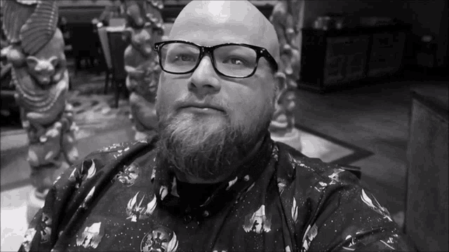 a bald man with glasses and a beard is wearing a shirt with star wars on it