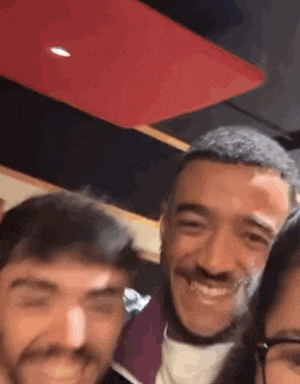 a group of people are posing for a picture together and smiling for the camera .
