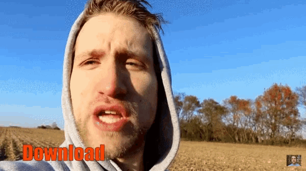 a man wearing a hooded sweatshirt with the words download behind him