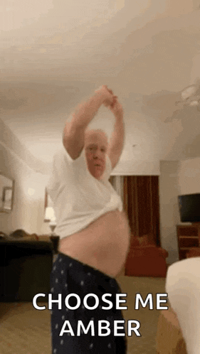 a man is dancing in a room with the words `` choose me amber '' written on the bottom .