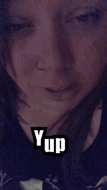 a close up of a woman 's face with the word yup written on it