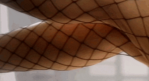 a close up of a woman 's legs in fishnet stockings