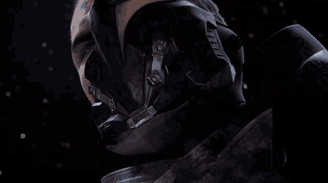 a close up of a man 's face with a helmet and gloves on