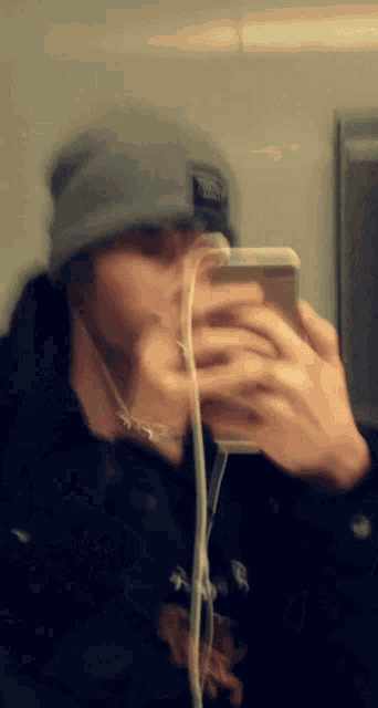 a blurry picture of a person taking a selfie