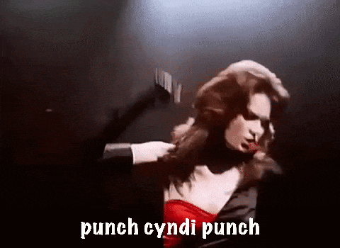 a woman in a red dress is being punched by a man