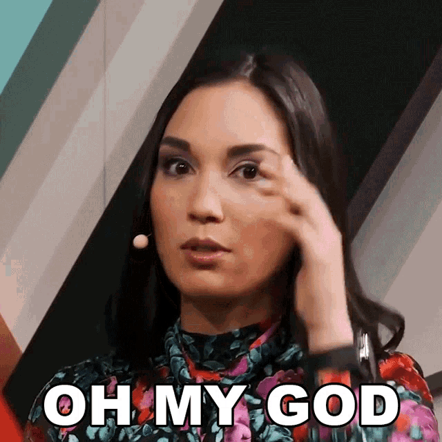 a woman in a floral top is making a face and says oh my god