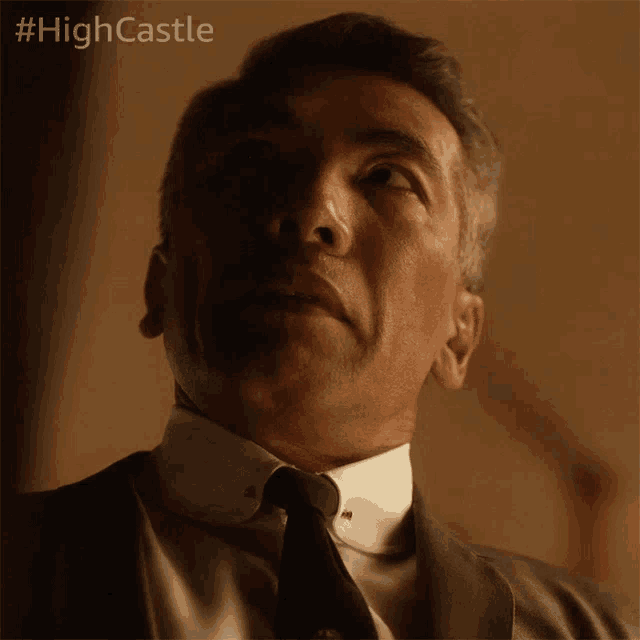 a close up of a man 's face with the hashtag #highcastle on the bottom