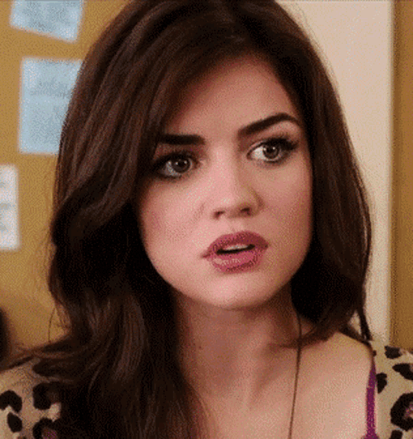 a close up of a woman with a surprised look on her face