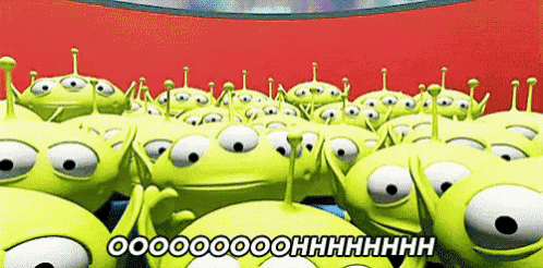 a bunch of toy story aliens are standing in a line