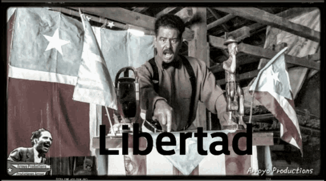 a black and white photo of a man giving a speech with the word libertad on the bottom right