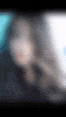 a blurred image of a person 's face with a blue and white background