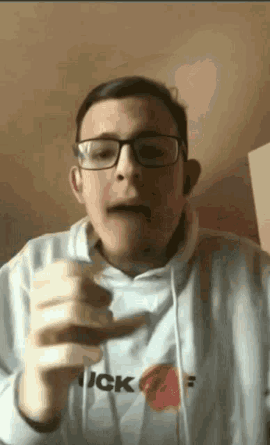 a young man wearing glasses and a hoodie that says jack on it