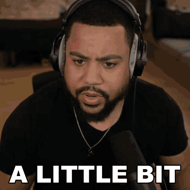 a man wearing headphones says a little bit in front of a microphone