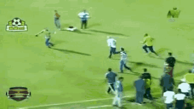 a man is laying on the ground on a soccer field with a sign that says soccer live