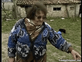 a woman in a blue and white sweater is standing in front of a stone building with the words freegifmaker.me below her