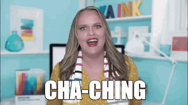 a woman says cha-ching in front of a computer screen