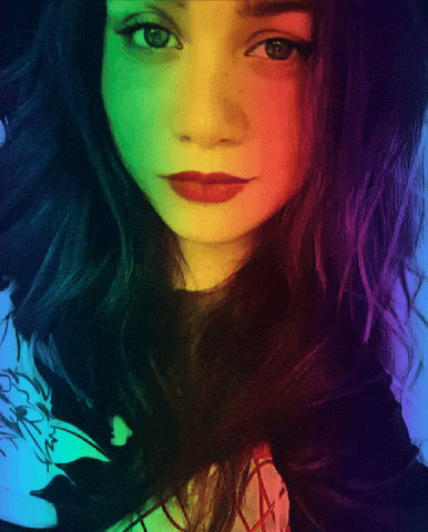 a close up of a woman with rainbow hair