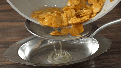 a pan of food is being poured into a bowl
