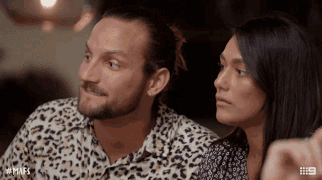 a man and a woman are sitting next to each other with the hashtag mafs