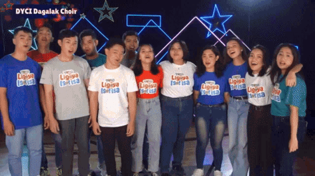 a group of people are posing for a picture and one of them is wearing a shirt that says ligaya