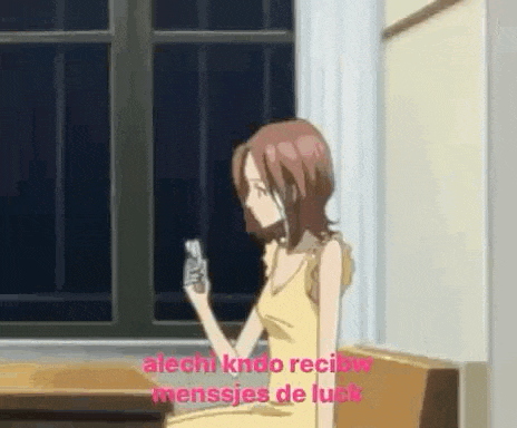 a girl is sitting at a table holding a cell phone in her hand .