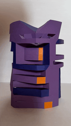 a purple and orange sculpture is stacked on top of each other on a table