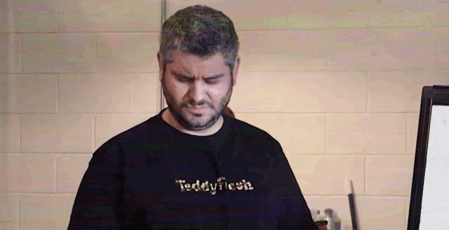 a man wearing a black teddy fresh t-shirt