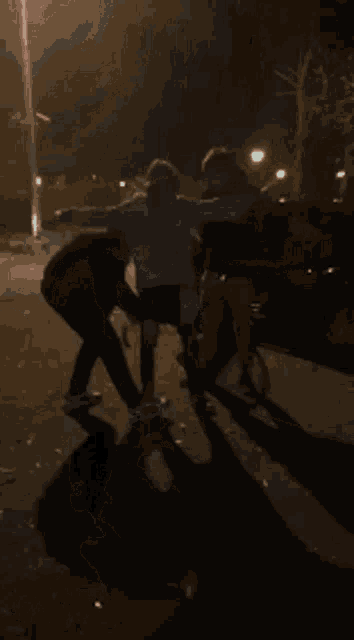 a blurry picture of people standing in the dark