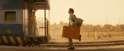 a man carrying a suitcase that says ' jack ' on it