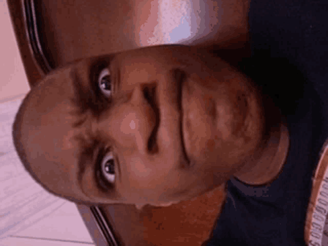 a close up of a man 's face with a shirt that says goodbye