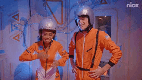 a man and a woman in space suits are standing next to each other with the nick logo in the corner