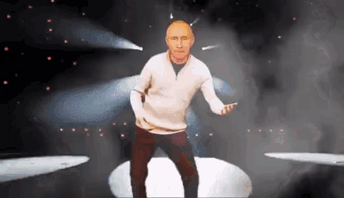 a man in a white sweater is dancing on stage