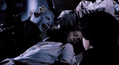 a girl is sleeping in a bed with a monster coming out of her head .