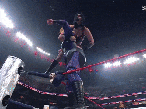 a woman in a wrestling ring with a w logo