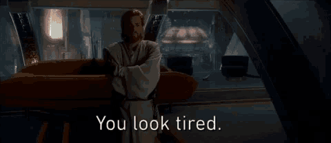 a man in a robe is standing in a room with the words you look tired written on the bottom