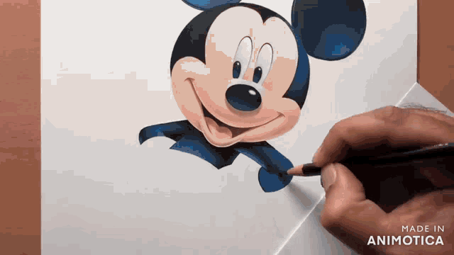 a person is drawing mickey mouse with a pencil