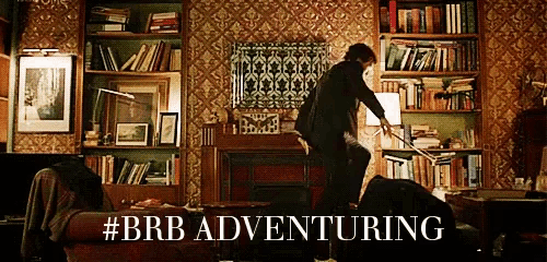 a man is holding a sword in a living room with the hashtag #brb adventuring above him