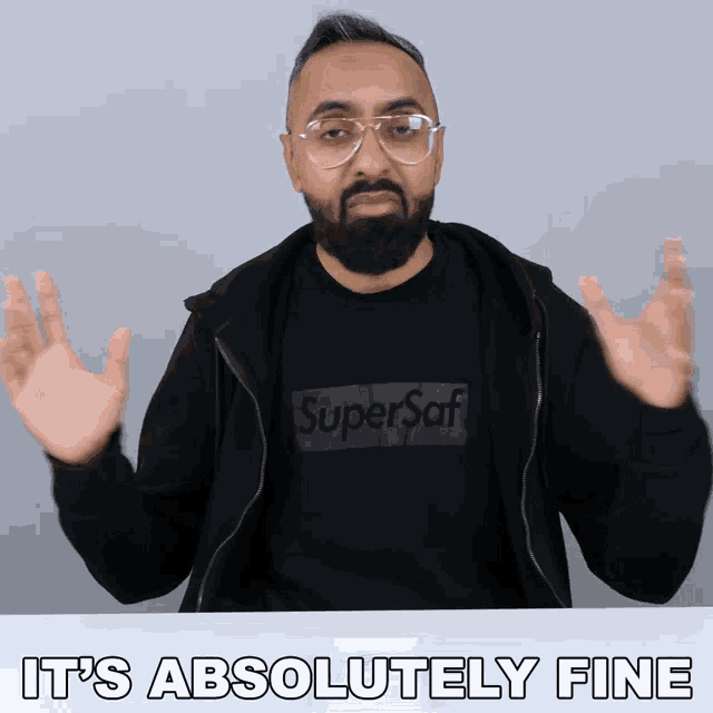 a man wearing a black sweatshirt that says super saf