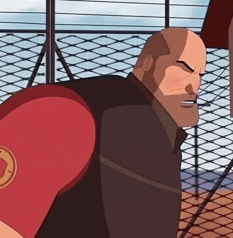 a bald man wearing a red boxing glove with a circle on it is standing in front of a chain link fence