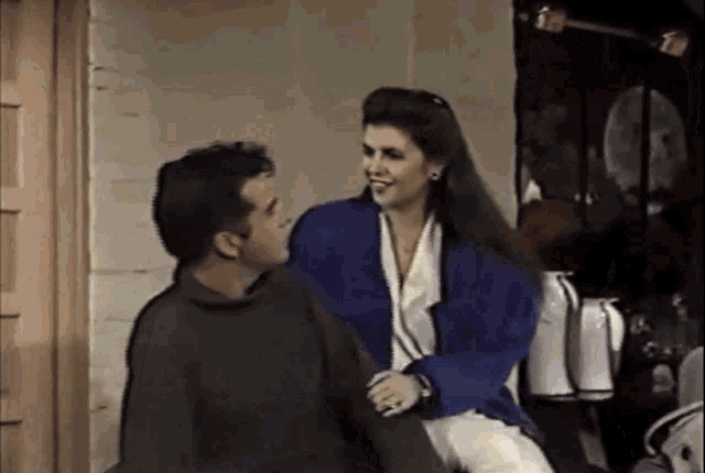 a man and a woman are sitting next to each other and talking