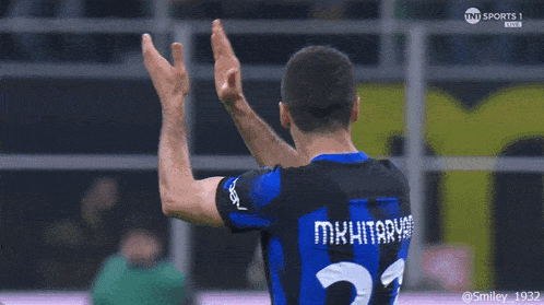 a soccer player wearing a number 23 jersey giving a high five
