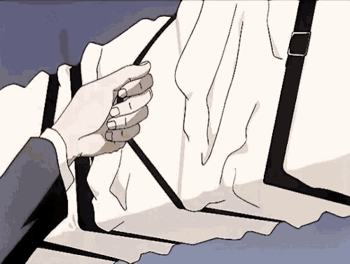 a person 's hand is reaching for a piece of white cloth