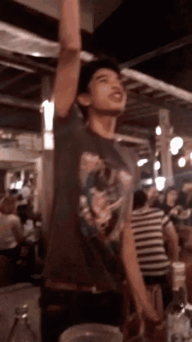 a man in a t-shirt with a skull on it is standing in a crowd