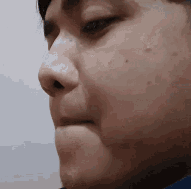 a close up of a man 's face with a tear running down his nose
