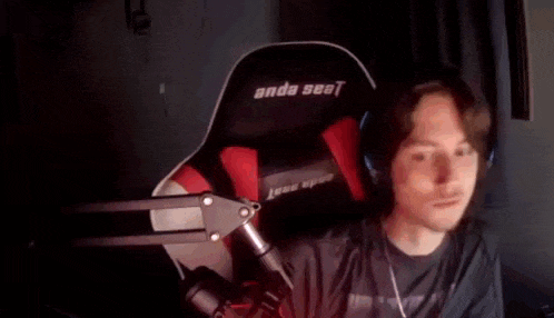 a man wearing headphones is sitting in a chair that says anda seat on it