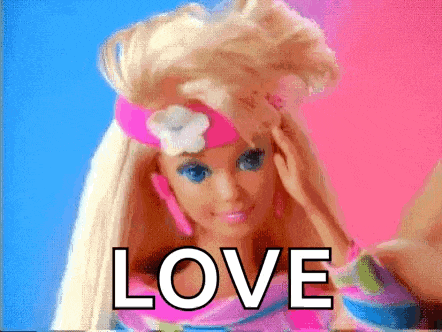 a barbie doll is wearing a pink headband with a flower on it and the word love is written on the screen .