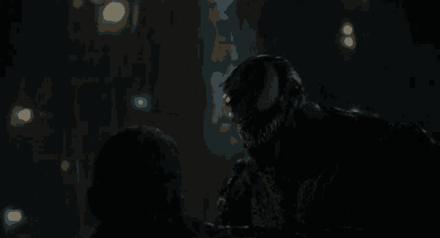 a close up of a person being attacked by a venom monster