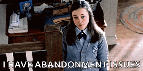 a girl in a school uniform is standing next to a staircase and says i have abandonment issues